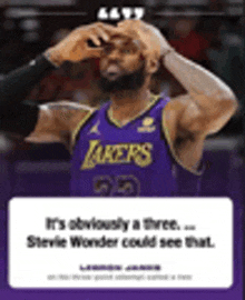 lebron james is wearing a purple lakers jersey and taking a picture of himself .