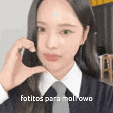 a girl wearing a tie and a white shirt is making a funny face and the caption says fotitos para moli owo .