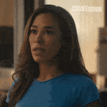 a woman in a blue shirt with the word countdown on the bottom right