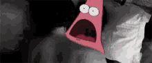 patrick star from spongebob squarepants is making a surprised face with his mouth open .