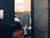a blurry picture of a person standing in a room with a sign that says ' a ' on it