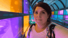 a woman is taking a selfie in a colorful tunnel