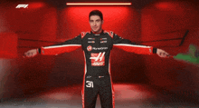 a man in a black and red racing suit with the number 31 on it