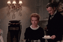 a man and a woman are sitting at a table with plates of food