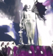 a statue of a man holding a bat is surrounded by purple letters