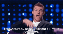 a man in a suit is talking about being released from being a prisoner in your own home .