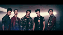 a group of young men are posing for a picture together