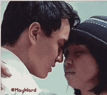 a man and a woman touching their foreheads with #mayward written on the bottom right