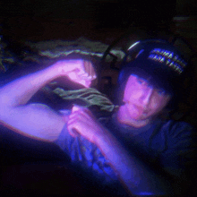 a man wearing headphones and a hat that says ' i 'm a soldier ' on it