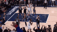 a basketball game is being played on a court that says la clippers on the side