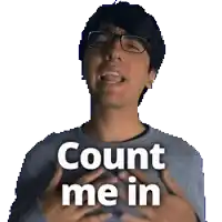 a man wearing glasses and a gray sweater says count me in