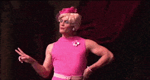a woman in a pink dress stands on a stage next to a group of girls and says no alcohol on the bottom