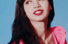 a close up of a woman wearing a pink dress