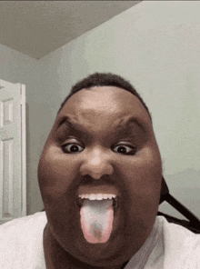 a man is sticking his tongue out in a funny face .