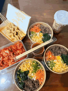 a table topped with bowls of food and a cup that says ' iced coffee ' on it