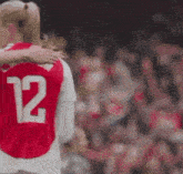 a soccer player with the number 12 on her back