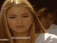 a close up of a woman 's face with the hashtag lialmeida05 on the bottom
