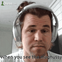 a man wearing headphones with the words when you see the magnussy below him