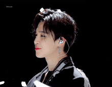 a close up of a person wearing earphones and a black jacket