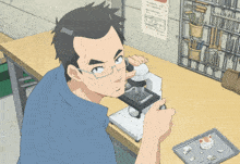 a man looking through a microscope with a calendar on the wall