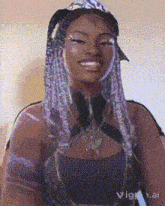 a woman with purple braids is smiling in a pixelated image