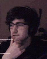 a man with glasses and headphones is thinking