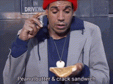 a man in a red hat is eating a peanut butter and crack sandwich .
