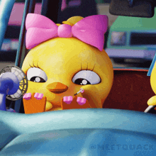 a cartoon chicken with a pink bow on her head is sitting in a car