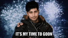 a man in a black jacket says it 's my time to goon in front of fireworks
