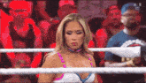 a woman in a wrestling ring with the letters n on her shirt