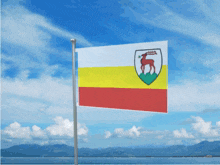 a flag with a deer on it flies in the wind