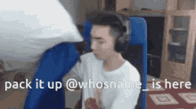 a man wearing headphones and a white shirt is sitting in a blue chair