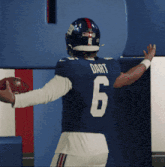 a football player named dart is holding a ball