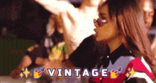 a woman wearing sunglasses is surrounded by people and the word vintage is above her