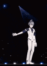 a man in a white suit is standing on a stage with his hands in the air