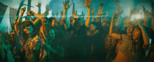 a crowd of people with their hands in the air at a party