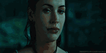 a close up of a woman 's face with water drops on her face and the words meganfoxrocksmyworld on the bottom