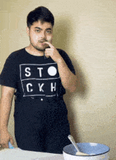 a man with a black shirt that says sto ckh