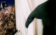 a person is opening a window with a knife