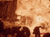 a group of people standing in front of a fire with the word brothers on the bottom left