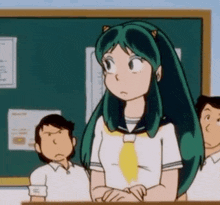 a girl with long green hair is standing in front of a blackboard in a classroom .