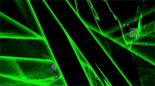 a person is standing in a dark room with green lights coming out of it .