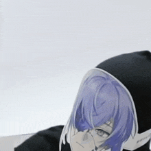 a person with purple hair wearing a black hoodie