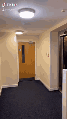 a hallway with a door and a sign that says ' no smoking '