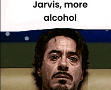 a man with a beard is laying on a couch under a sign that says jarvis , more alcohol