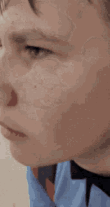 a close up of a person 's face with a bandage on his nose .