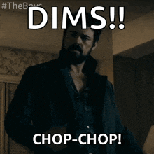 a man with a beard is standing in a dark room and says dims chop-chop