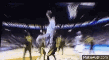 a blurry picture of a basketball game being played on make a gif.com