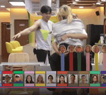 a man and a woman are hugging in a room with a bunch of pictures of people