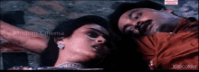 a man and a woman are laying next to each other in a modern cinema video